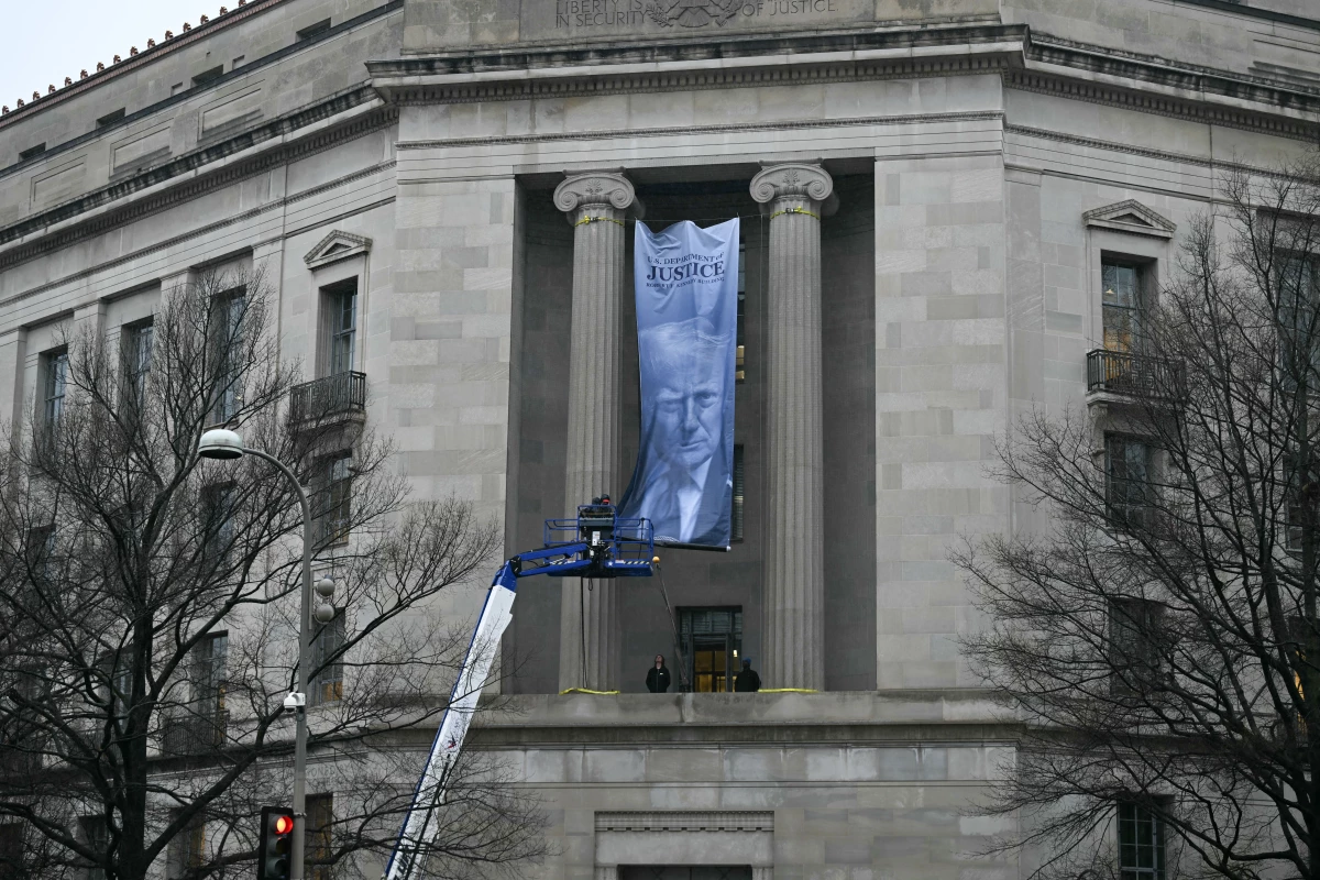 Workers hung this banner in February from the Department of Justice headquarters. Visitors and scholars liken it to the political iconography seen in authoritarian states such as China and the former Soviet Union.