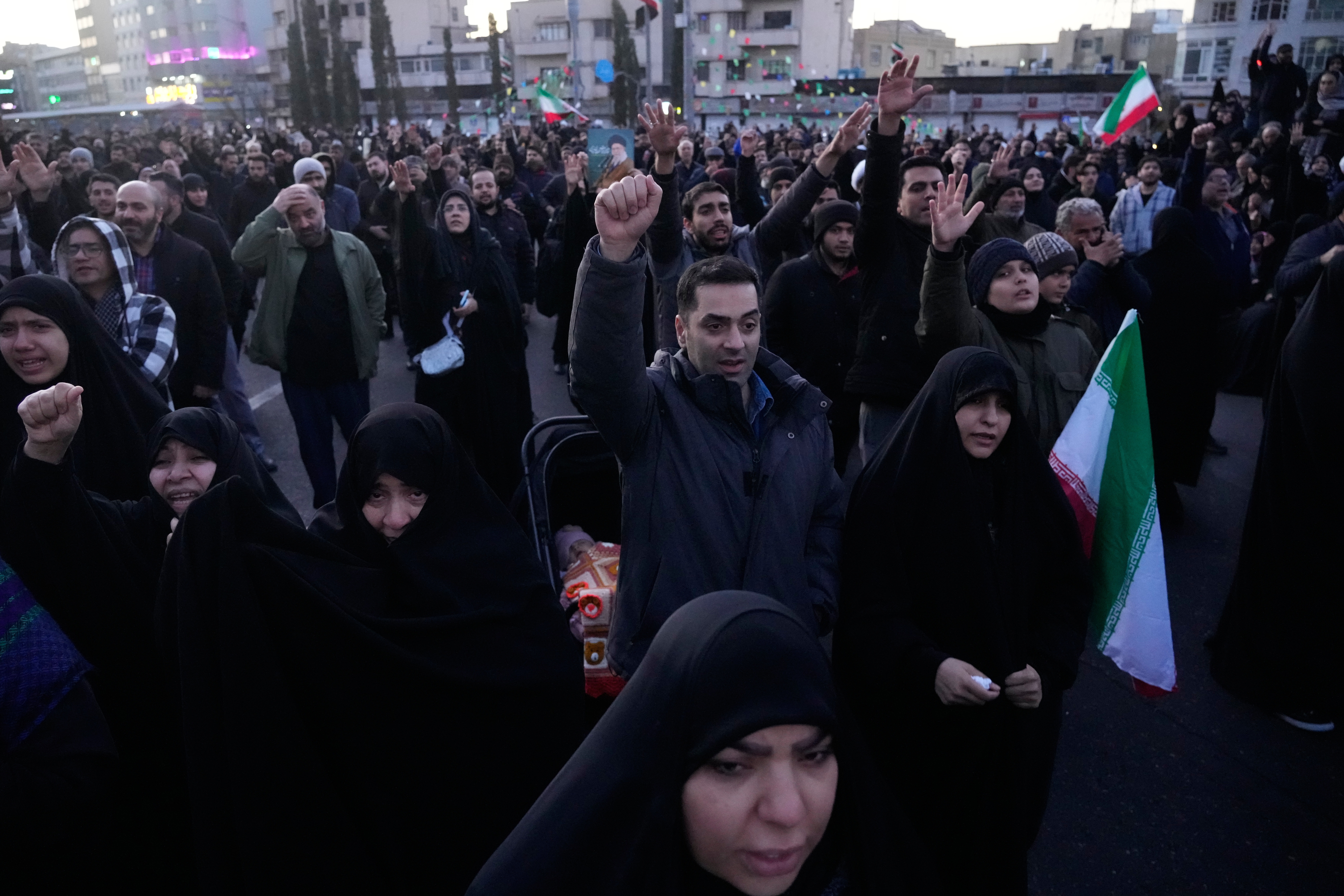 Government supporters chant slogans as they gather in mourning after state TV officially announced the death of Iranian Supreme Leader Ayatollah Ali Khamenei, in Tehran, Iran, Sunday, March 1, 2026.