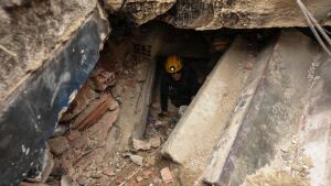 A member of the Los Angeles County Fire Department moves through the rubble of a building that collapsed from earthquakes in La Guaira, Venezuela, Tuesday.