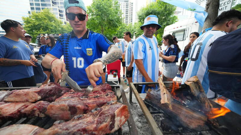 Matias Videla, of Dallas, a supporter of Argentina, checks meat on his grill during a rally ahead of his team's World Cup Group J soccer match against Austria, Sunday, June 21, 2026, in Dallas.