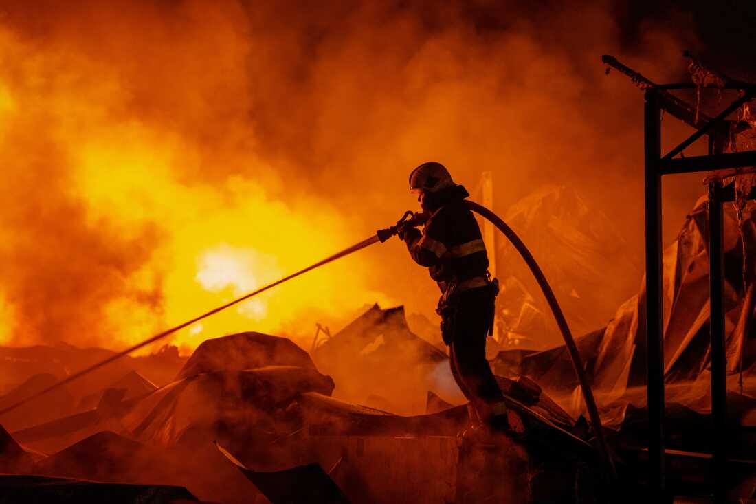 Firefighters put out a fire after Russian missiles hit a warehouse in Kyiv, Ukraine, Wednesday, Aug. 5, 2026.