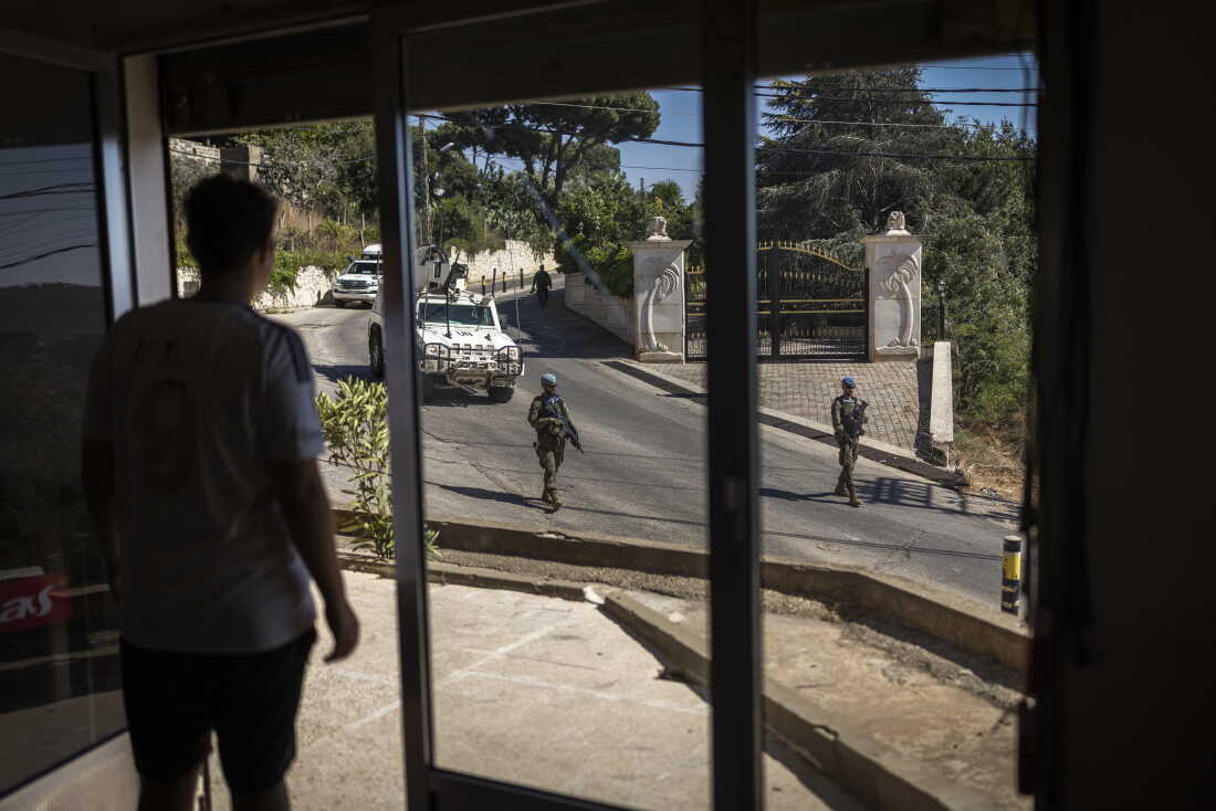 A young Christian observes a Spanish UNIFIL battalion patrolling the streets of the Christian village of Ibel al-Saqi. UNIFIL has resumed street patrols following the escalation of hostilities in March 2026, which has killed more than 4,354 people across Lebanon, according to the Lebanese Health Ministry