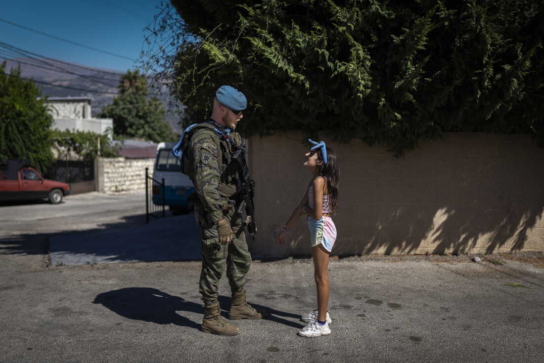 A Lebanese girl speaks with a Spanish UNIFIL soldier as he patrols the streets of the Christian village of Ibel al-Saqi. Since September 2006, the Spanish Armed Forces have been deployed in Lebanon. Over the years, the Spanish contingent has carried out numerous civil-military cooperation (CIMIC) activities aimed at strengthening ties with local communities.