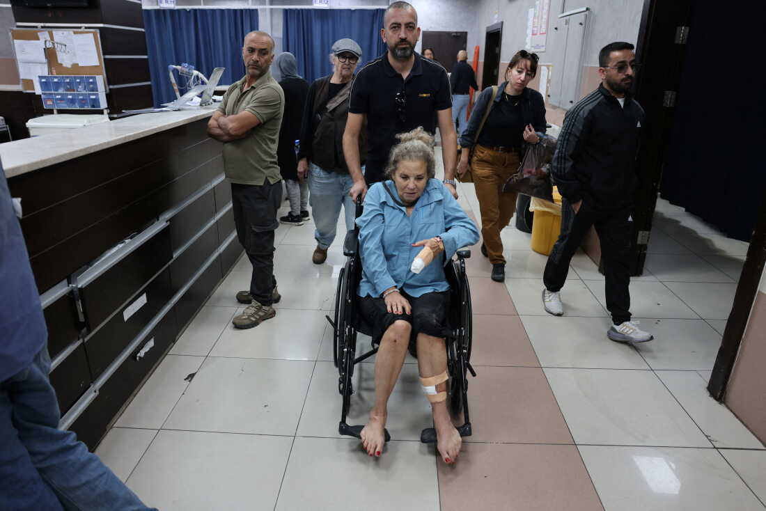 Photojournalist Heidi Levine leaves a hospital emergency room in a wheelchair in the Israeli-occupied city of Ramallah, West Bank. She's being treated after an attack by Israeli settlers as she was photographing Palestinian farmers harvesting their olives, in the Palestinian village of Abu Falah on Friday.