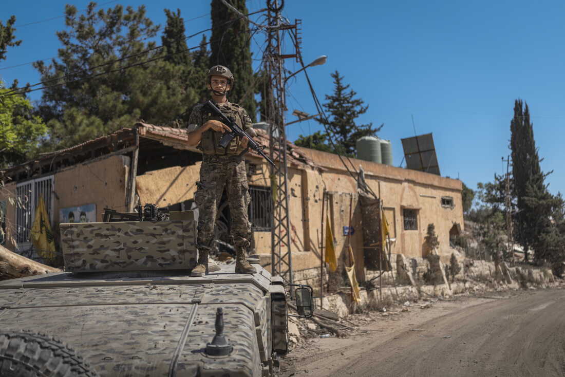 A Lebanese Armed Forces (LAF) soldier stands outside an armored vehicle at the “temporary checkpoint” separating the IDF positions from the area where Israeli forces have withdrawn, and local residents have begun returning to Zawtar al-Gharbieh.