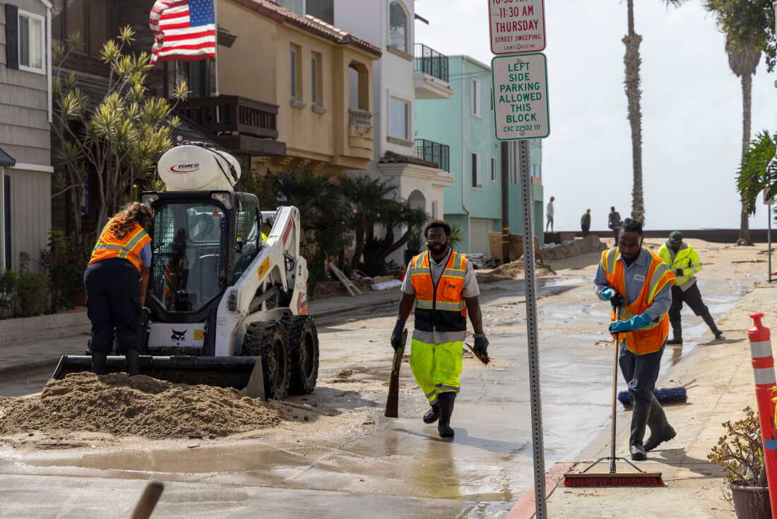 Long Beach Public Works workers clean up along Alamitos Peninsula in Long Beach, Calif. that was affected by Tropical Storm Rachel, Sunday, Oct. 11, 2026.