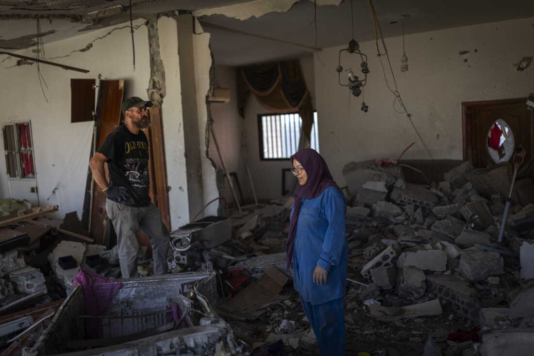 Mahasen Fakih in her destroyed apartment. She returned to Zawtar al-Gharbieh recently after being displaced to the Chouf region, but there is still fighting nearby. "The explosions don't stop throughout the night. I can barely sleep," she said.