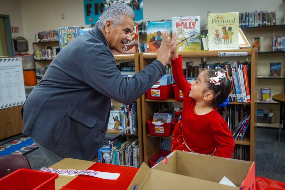 Tribal Council President Martin Harvier greets each student with stickers and high-fives as they drop their ballots into a box.