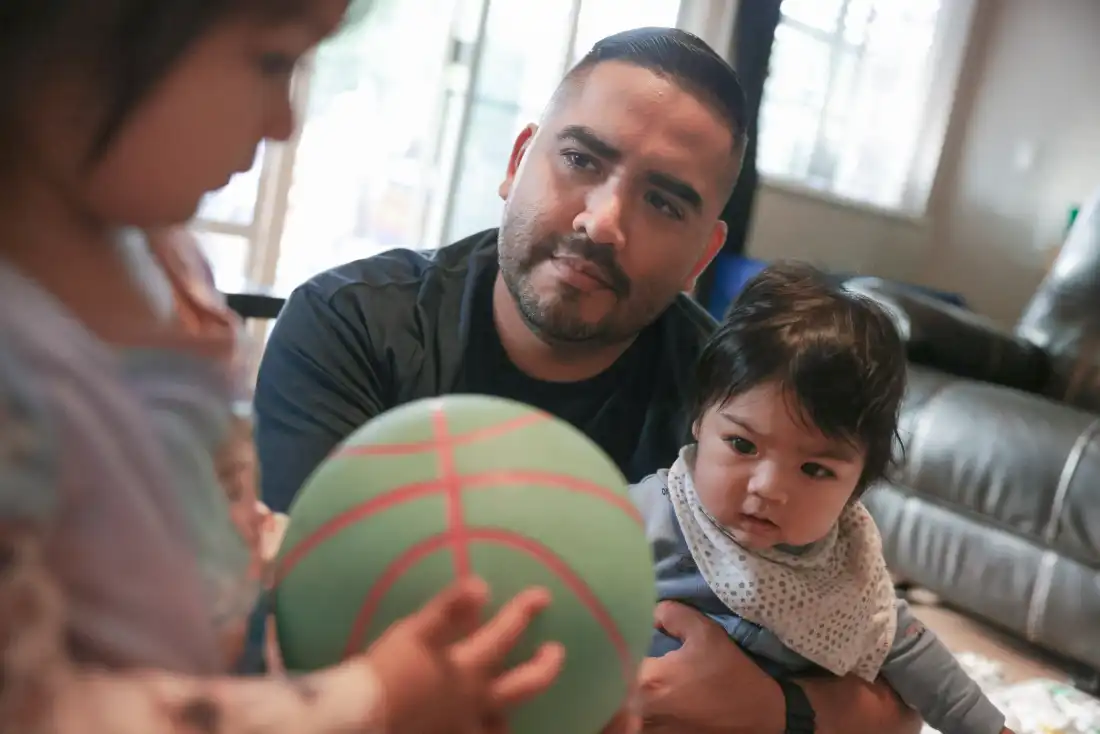 Karlo Campana plays with his daughter Giselle and his infant son Gianluca at home on October 12 in Santa Ana, Calif. With three children under 4, paid paternity leave gave him something invaluable: time to bond with his kids and support his wife in the thick of early parenthood.