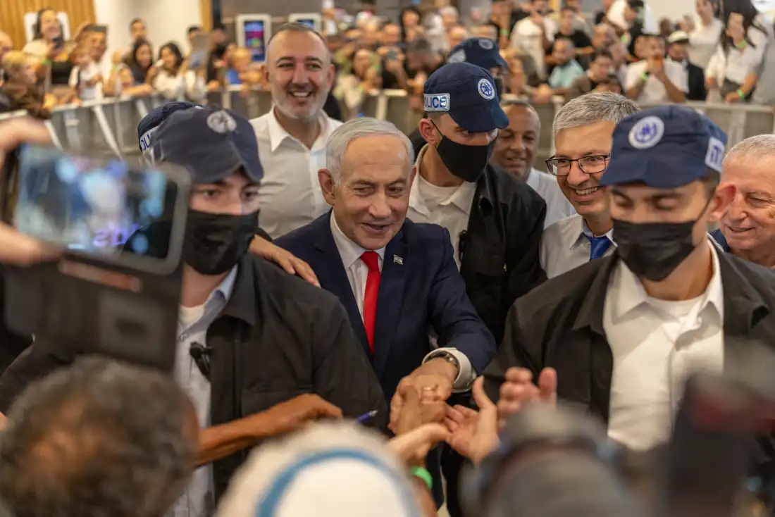 Israeli Prime Minister Benjamin Netanyahu stands amid security personnel as he meets with voters at a mall in Ramle, Israel on Oct. 19, 2026.