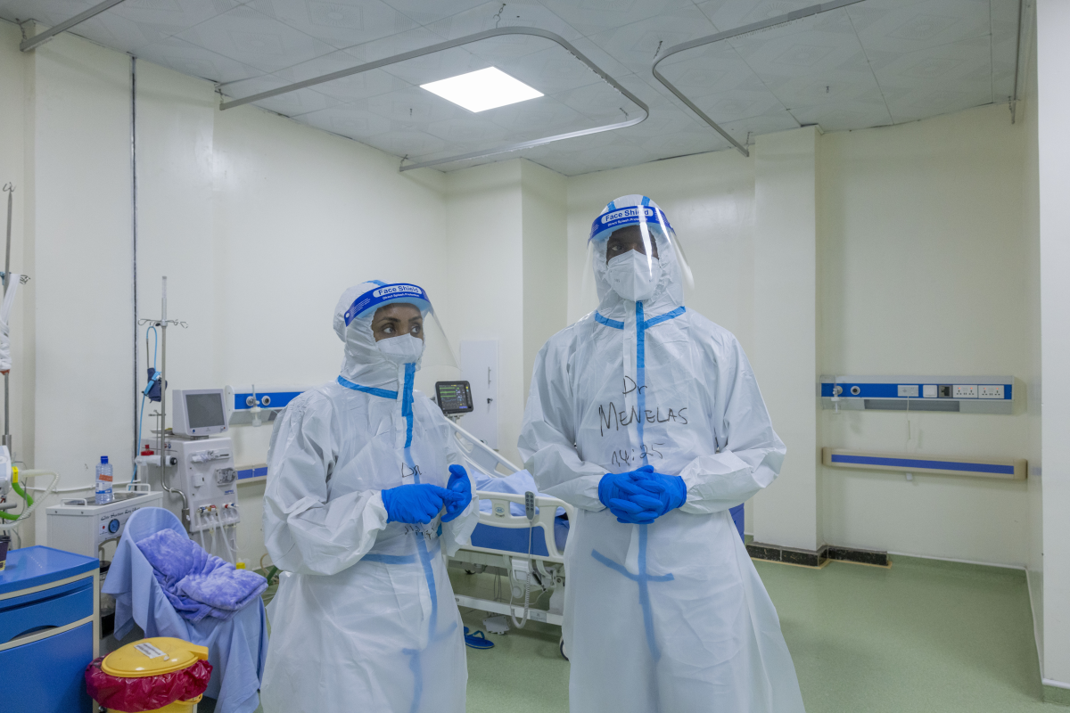 Dr. Tsion stands next her colleague Dr. Nkeshiman Menelas in a treatment center for Marburg patients in Kigali, Rwanda.