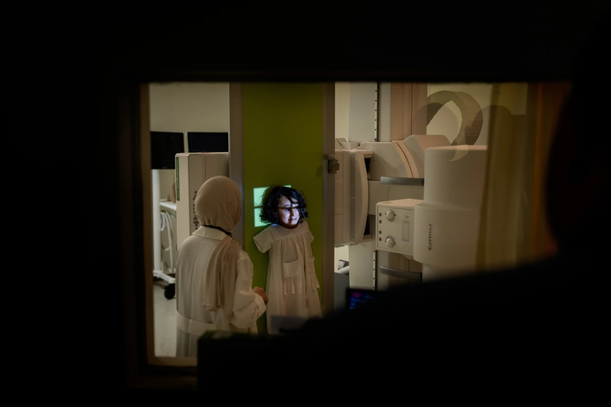 Kenzi Madhoun is examined at the American University of Beirut Medical Center. She was injured during an Israeli air strike. 'The missile took me up,' she says. Kenzi felt like she was flying, like — in her words — Superman or Batman. When she landed, she lost consciousness. She was pulled from the rubble alive but with serious injuries.