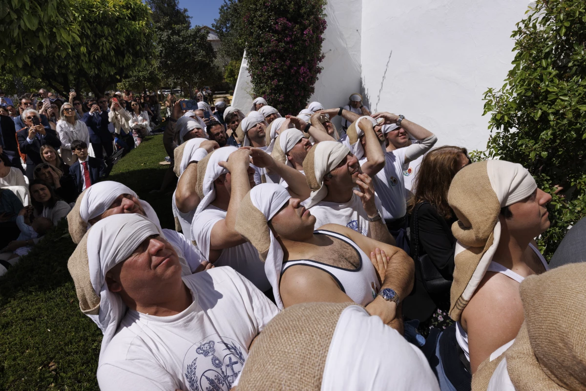 Costaleros carry the heavy religious floats that are paraded around during Holy Week in Seville.