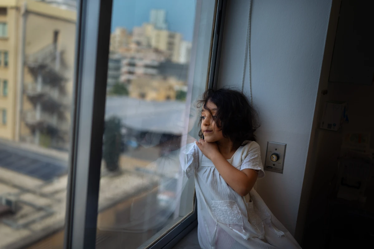 Kenzi Madhoun looks out from a hospital room in Beirut where she is being treated by Dr. Ghassan Abu-Sittah and his team.