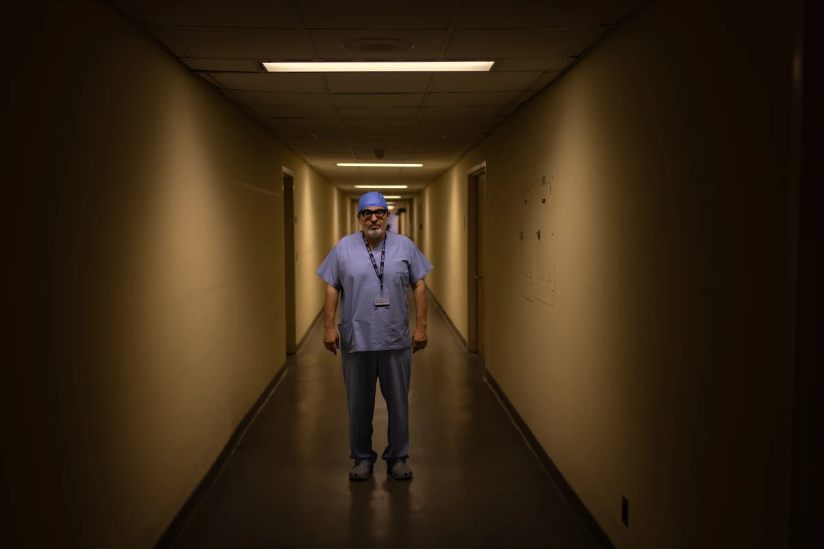 Dr. Ghassan Abu-Sittah stands in a corridor at the American University of Beirut Medical Center. He is a reconstructive and plastic surgeon who treats those wounded in war, including, by his estimate, thousands of children.