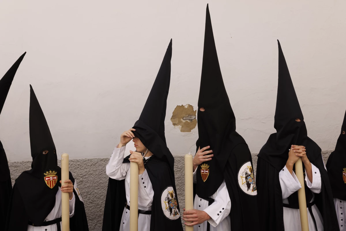 Penitents of Santa Genoveva brotherhood wait before taking part in a procession during Holy Week (Semana Santa) observances on March 30 in Seville, Spain.