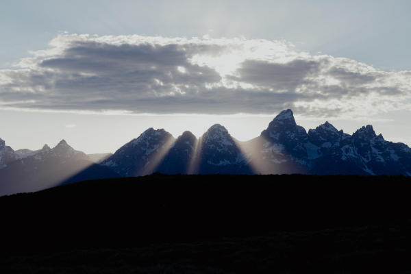 The sun sets behind the Grand Teton Mountains.
