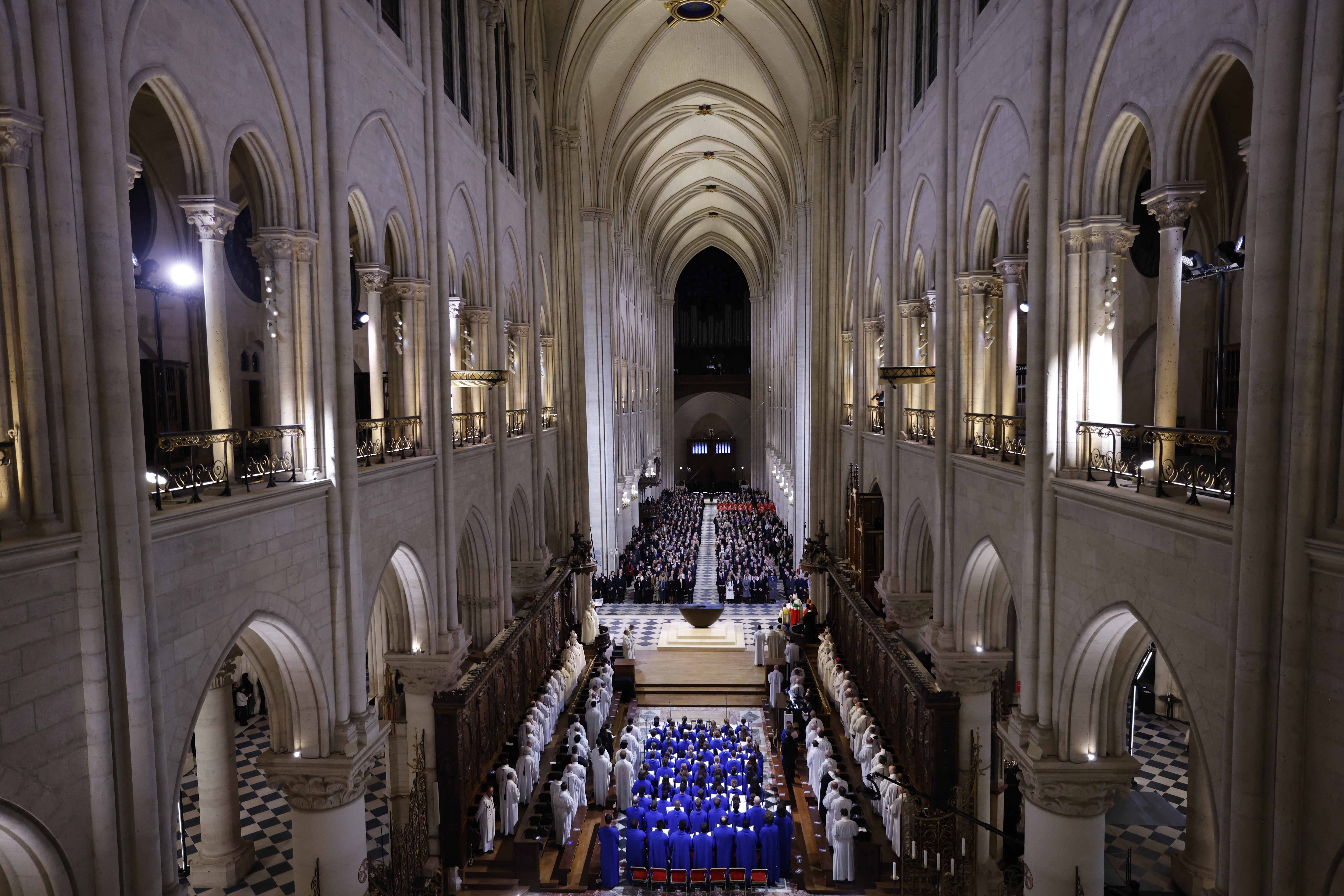 The choir, clergy and guests stand as they sing during a ceremony to mark the reopening of the landmark Notre-Dame Cathedral, in central Paris, on Saturday.