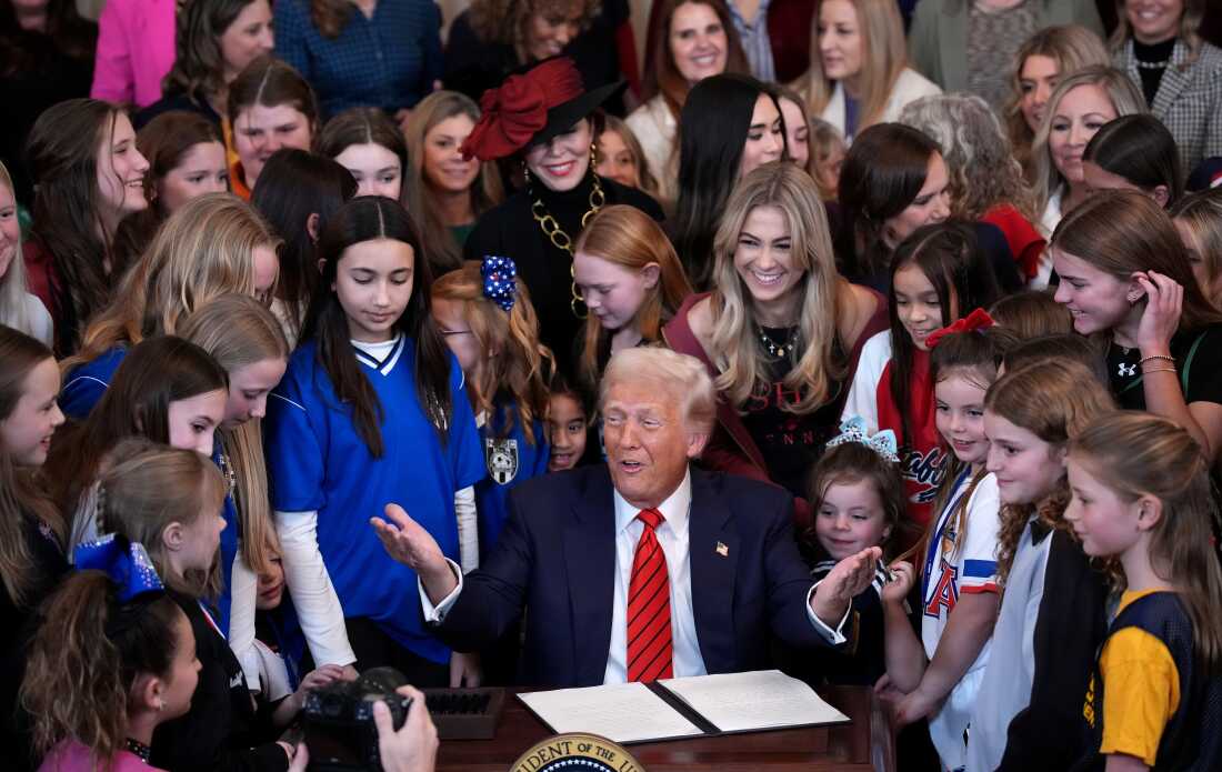 President Trump, surrounded by young female athletes, signs the “No Men in Women’s Sports” executive order at the White House in February 2025.