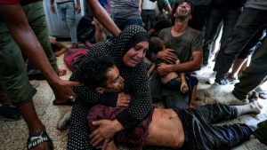 Faten Mreish holds her son's body at a hospital morgue in Deir al-Balah, Gaza Strip, Aug. 28, 2024, after he and others were killed in an Israeli bombardment.