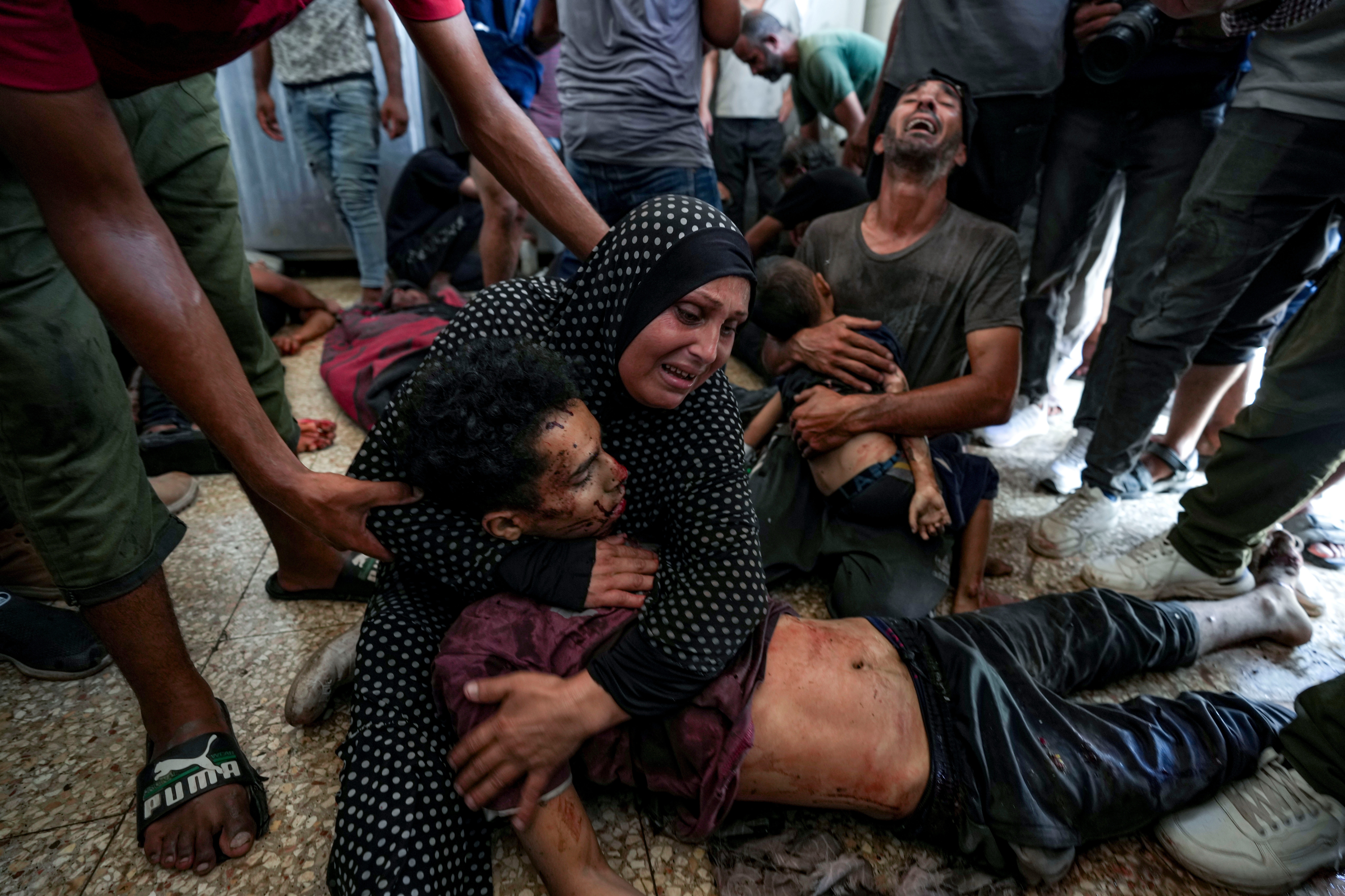 Faten Mreish holds her son's body at a hospital morgue in Deir al-Balah, Gaza Strip, Aug. 28, 2024, after he and others were killed in an Israeli bombardment. (AP)