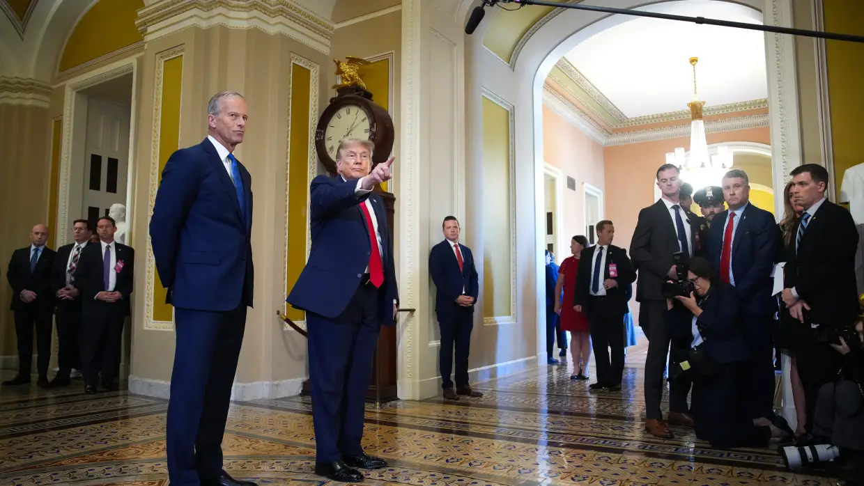 Senate Majority Leader John Thune, R-S.D., watches as President Trump speaks to the media as they arrive at the Capitol on Wednesday.