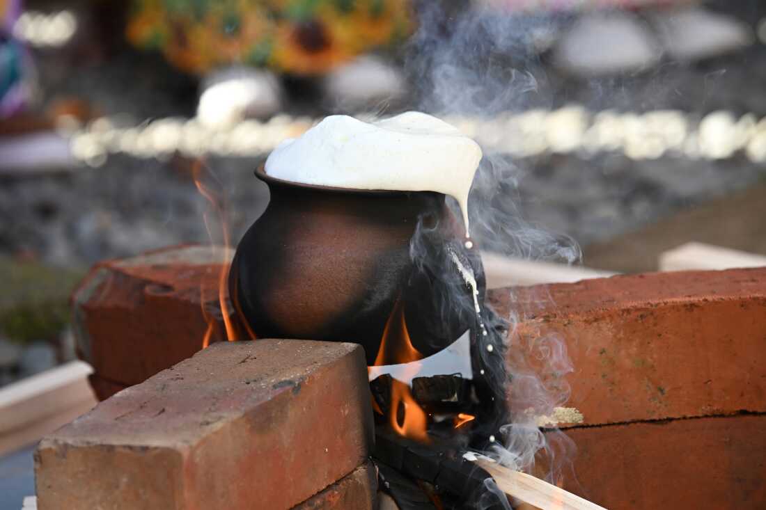 Members of the Sri Lankan community are boiling fresh milk in a new clay pot and allowing it to overflow as a traditional way of invoking blessings during the Sinhalese and Tamil New Year celebrations at Samadhi Buddhist Temple in Rolleston, New Zealand, on April 14, 2024. Sri Lankan Buddhists and Tamil Hindus celebrate their annual traditional new year based on the astrological belief that signifies the beginning of the new year when the sun moves from the house of Pisces to that of Aries. This day also marks the end of the harvest season and spring in Sri Lanka. (Photo by Sanka Vidanagama/NurPhoto via Getty Images)