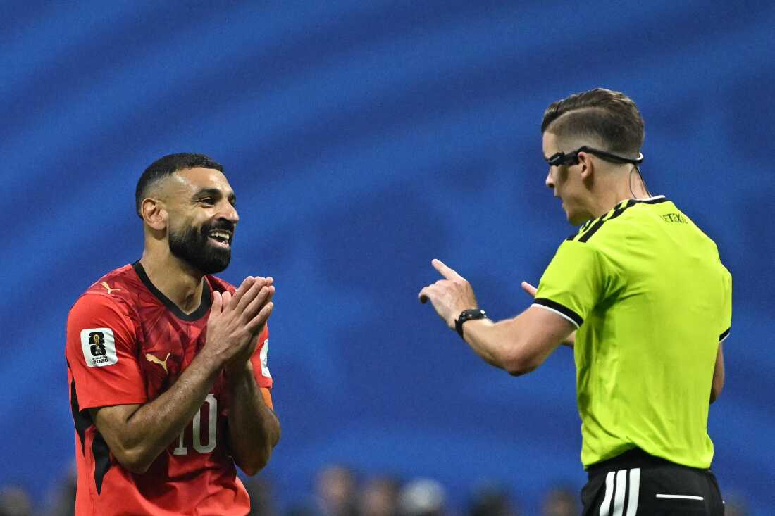 French referee François Letexier speaks with Egypt forward Mohamed Salah during the World Cup Round of 16 match between Argentina and Egypt in Atlanta.