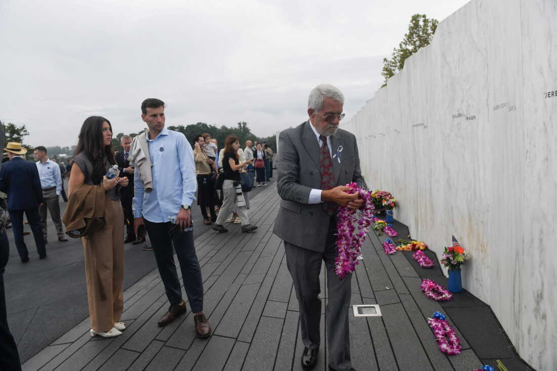 Visitors pay their respects at the Wall of Names shortly before a ceremony honoring those who died aboard Flight 93 on September 11, 2001 at the Flight 93 Natio