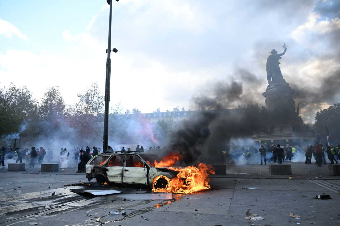 A car burns at Place de La Republique during a protest against rising living costs in Paris on Saturday.