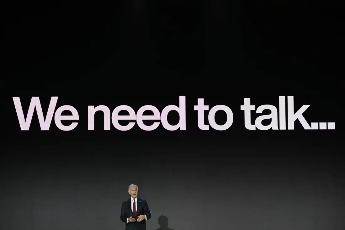 Medicare chief Dr. Mehmet Oz is shown standing in front of a huge screen displaying the words, "We need to talk ..."