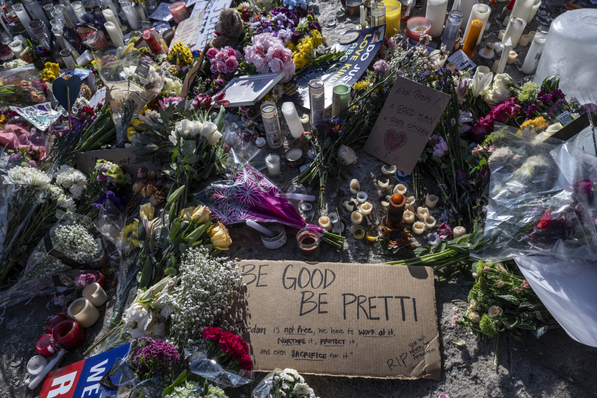 Flowers, signs and mementos are seen Monday at a makeshift memorial in the area where Alex Pretti was shot dead by federal immigration agents in Minneapolis. On January 24, federal agents shot and killed Pretti, a 37-year-old ICU nurse, while scuffling with him on an icy roadway.