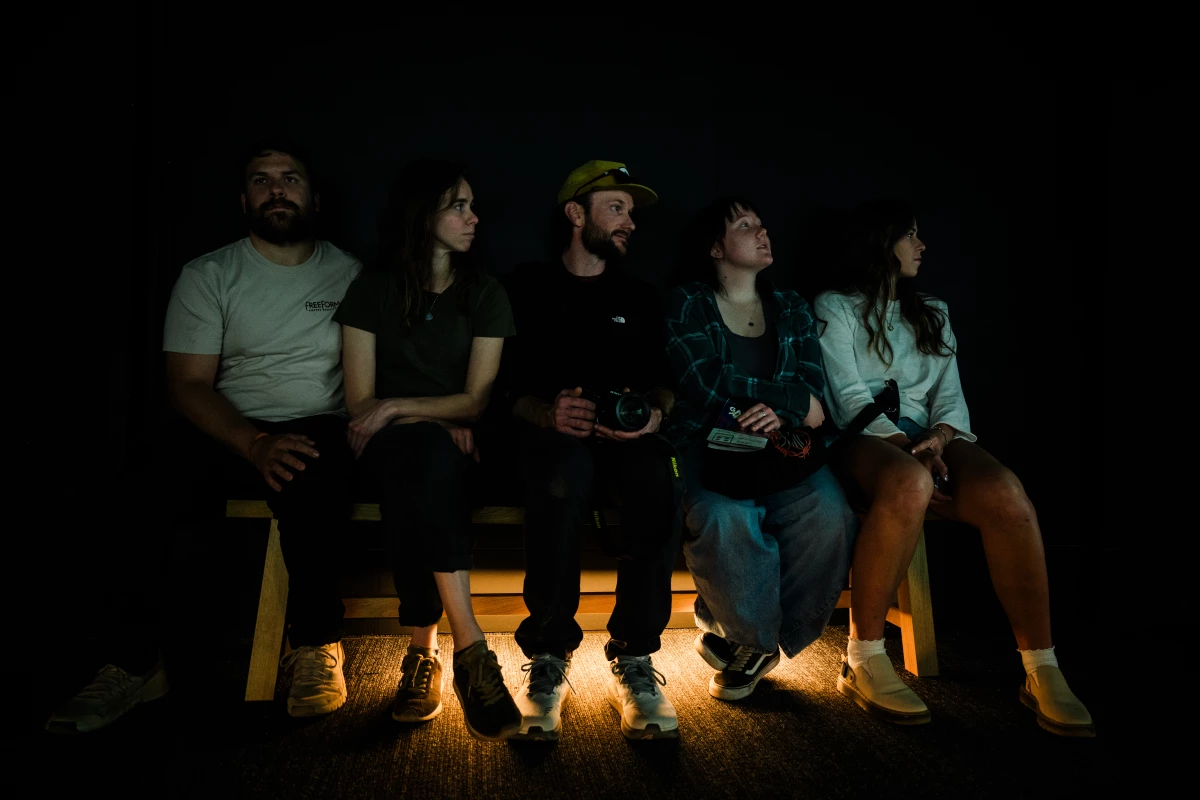 A group of friends sits in The RAF Exhibit Gallery and watch FRAMERATE: Desert Pulse on April 14, 2026 at Desert Botanical Garden in Phoenix, Arizona.
