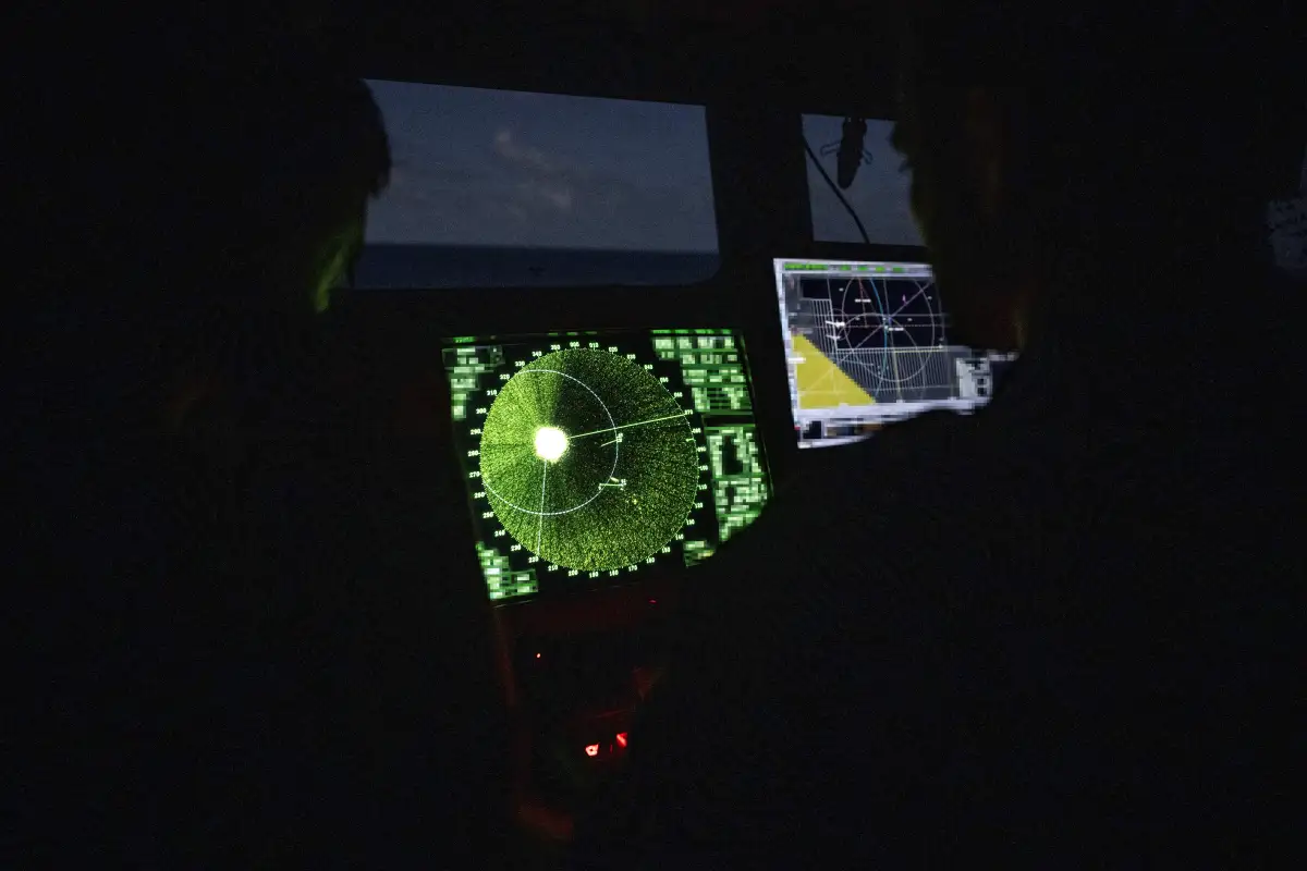 Members of the French Navy monitor radar in the control bridge in low light conditions during an anti-drug interception mission by the French surveillance frigate FS Ventose sailing off the French Caribbean island of Martinique, on November 16, 2024.