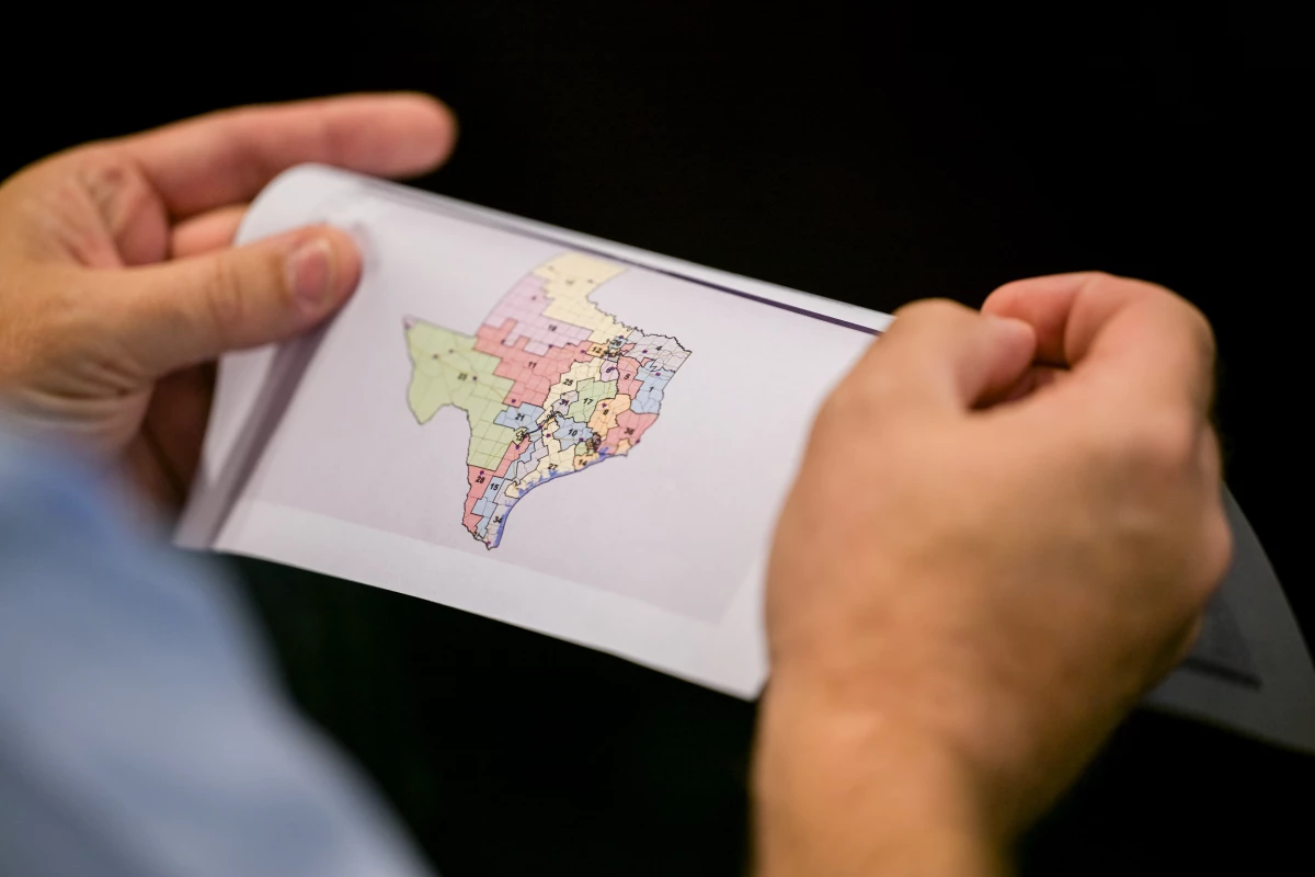 A person views a map during a Senate Special Committee on Congressional Redistricting public testimony hearing on Aug. 7 in Austin, Texas.