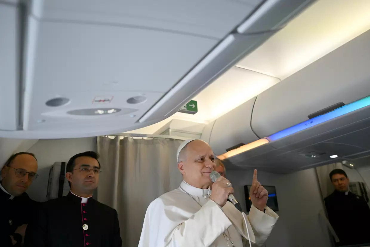 Pope Leo XIV speaks to journalists aboard his flight bound for Algiers' Houari Boumédiène International Airport on Monday, April 13, 2026, at the start of an 11-day apostolic journey to Africa.