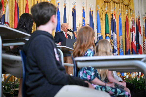 At a White House event on Thursday, President Trump signed an executive order aimed at closing the U.S. Education Department. He was surrounded by students sitting in desks and Republican governors.