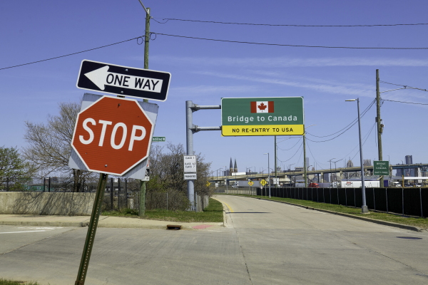 Signs notify drivers at the U.S.-Canada Ambassador Bridge border crossing in Detroit, Michigan.