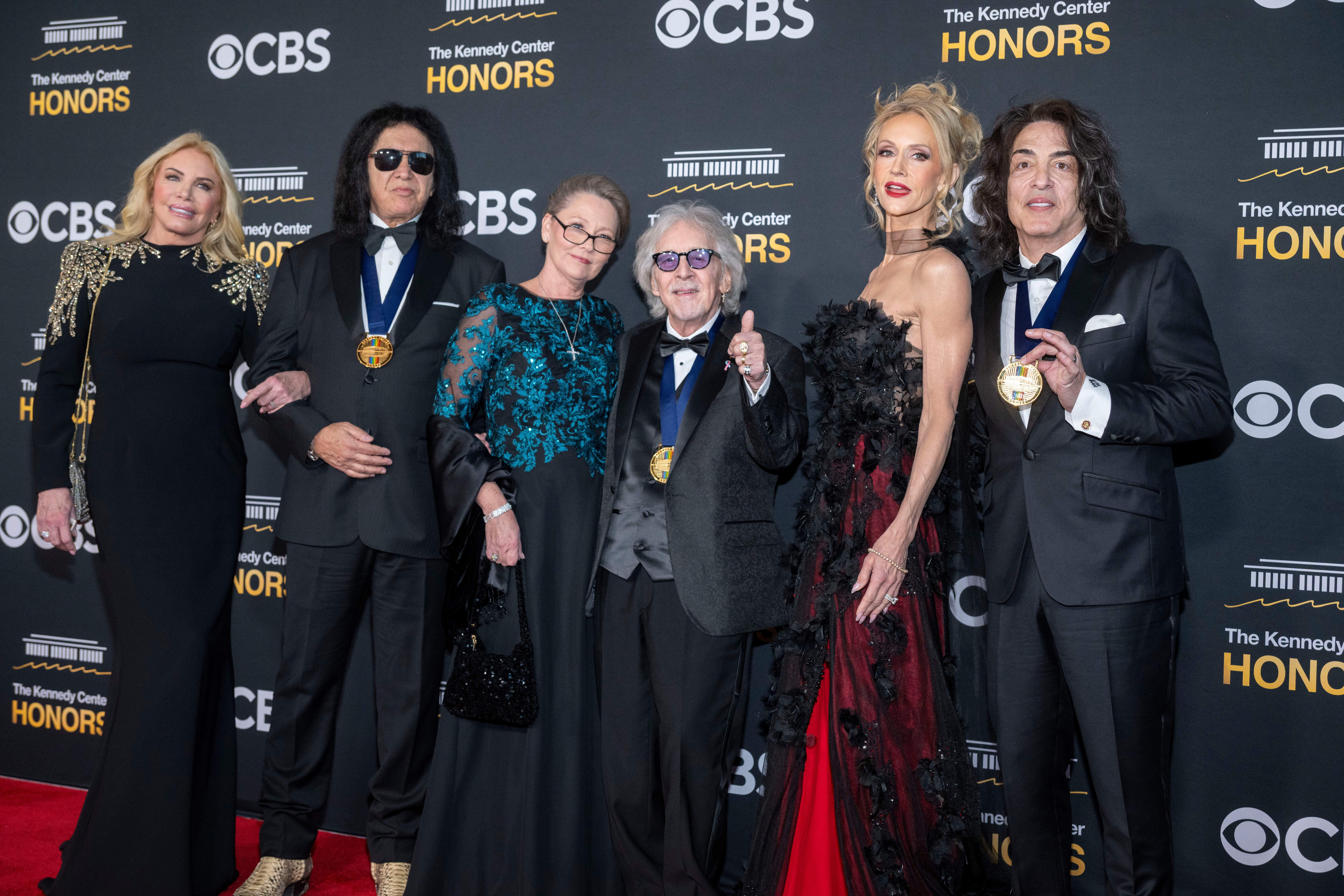 From left, Shannon Tweed Simmons, 2025 Kennedy Center Honoree and member of rock band KISS Gene Simmons, Gigi Criss, 2025 Kennedy Center Honoree and member of rock band KISS Peter Criss, Erin Stanley and 2025 Kennedy Center Honoree and member of rock band KISS Paul Stanley pose on the red carpet for the 48th Kennedy Center Honors at the Kennedy Center for the Performing Arts. (AP)