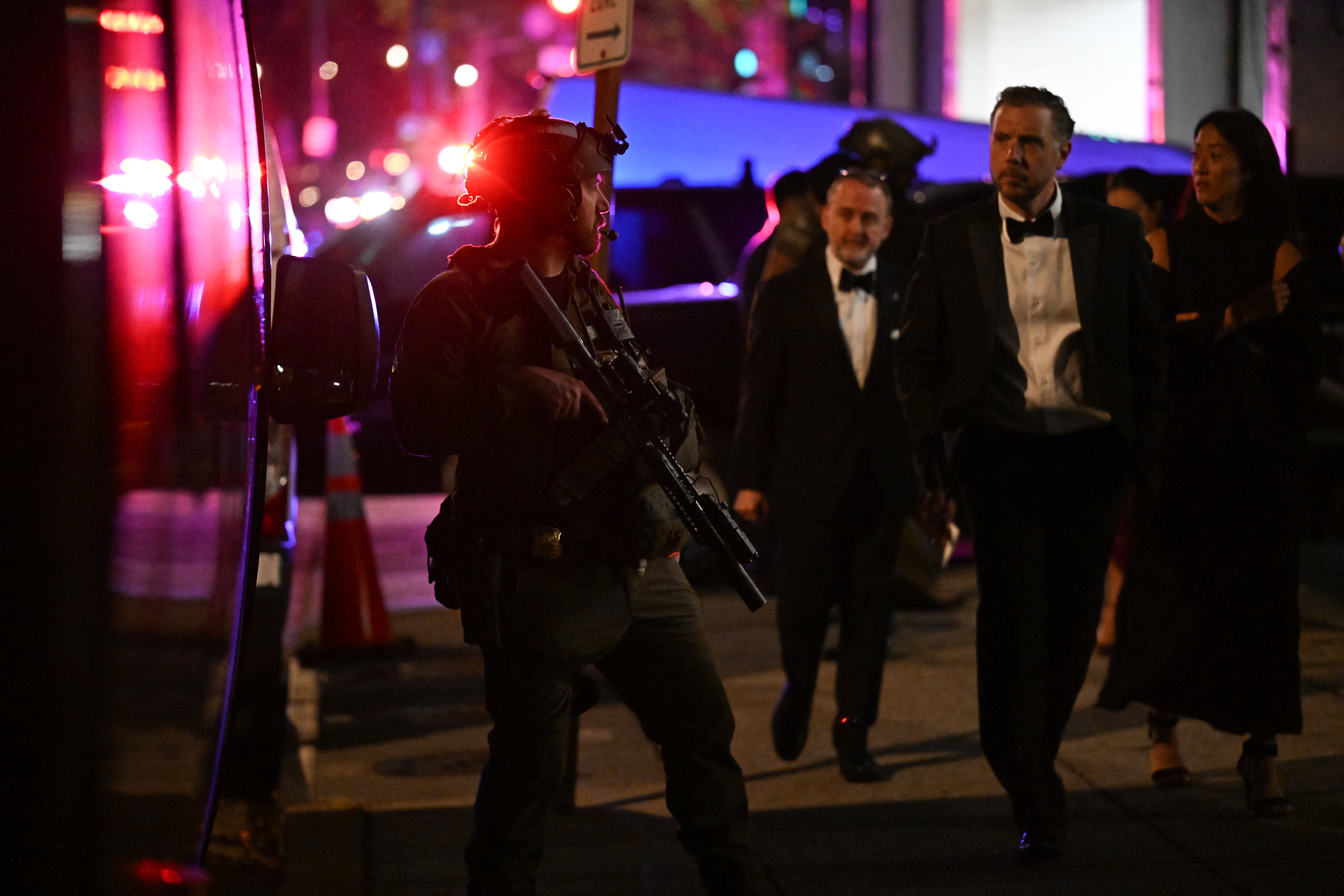 Armed commandos stand by as special guests are evacuated from the back of the Washington Hilton after shots were reportedly fired during the White House Correspondents