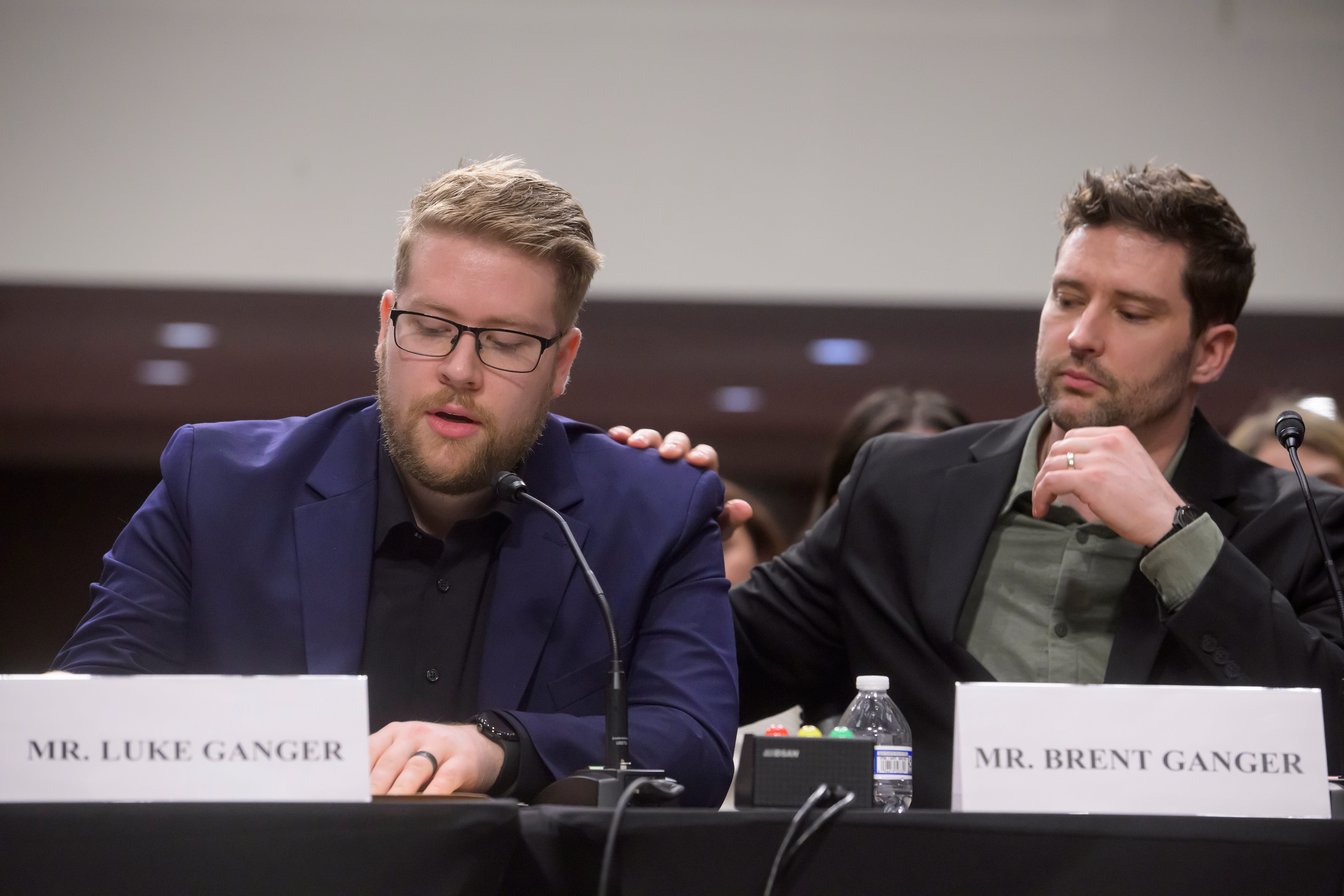 Luke Ganger, left, and Brent Ganger, right, brothers of Renee Good, appear during a Bicameral Public Forum on the Disproportionate Use of Force by DHS Agents, on Capitol Hill, Tuesday, Feb. 3, 2026, in Washington.