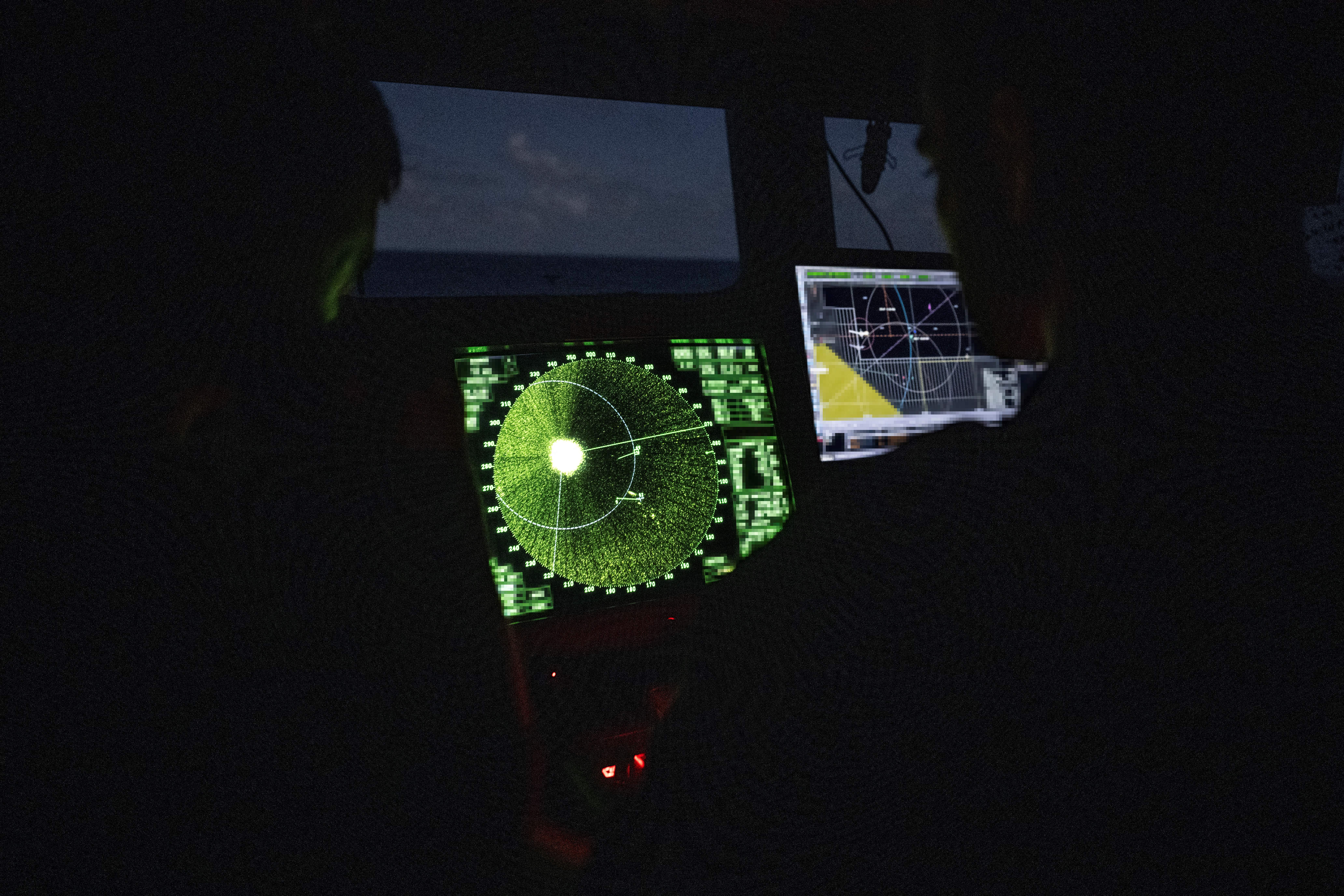 Members of the French Navy monitor radar in the control bridge in low light conditions during an anti-drug interception mission by the French surveillance frigate FS Ventose sailing off the French Caribbean island of Martinique, on November 16, 2024.