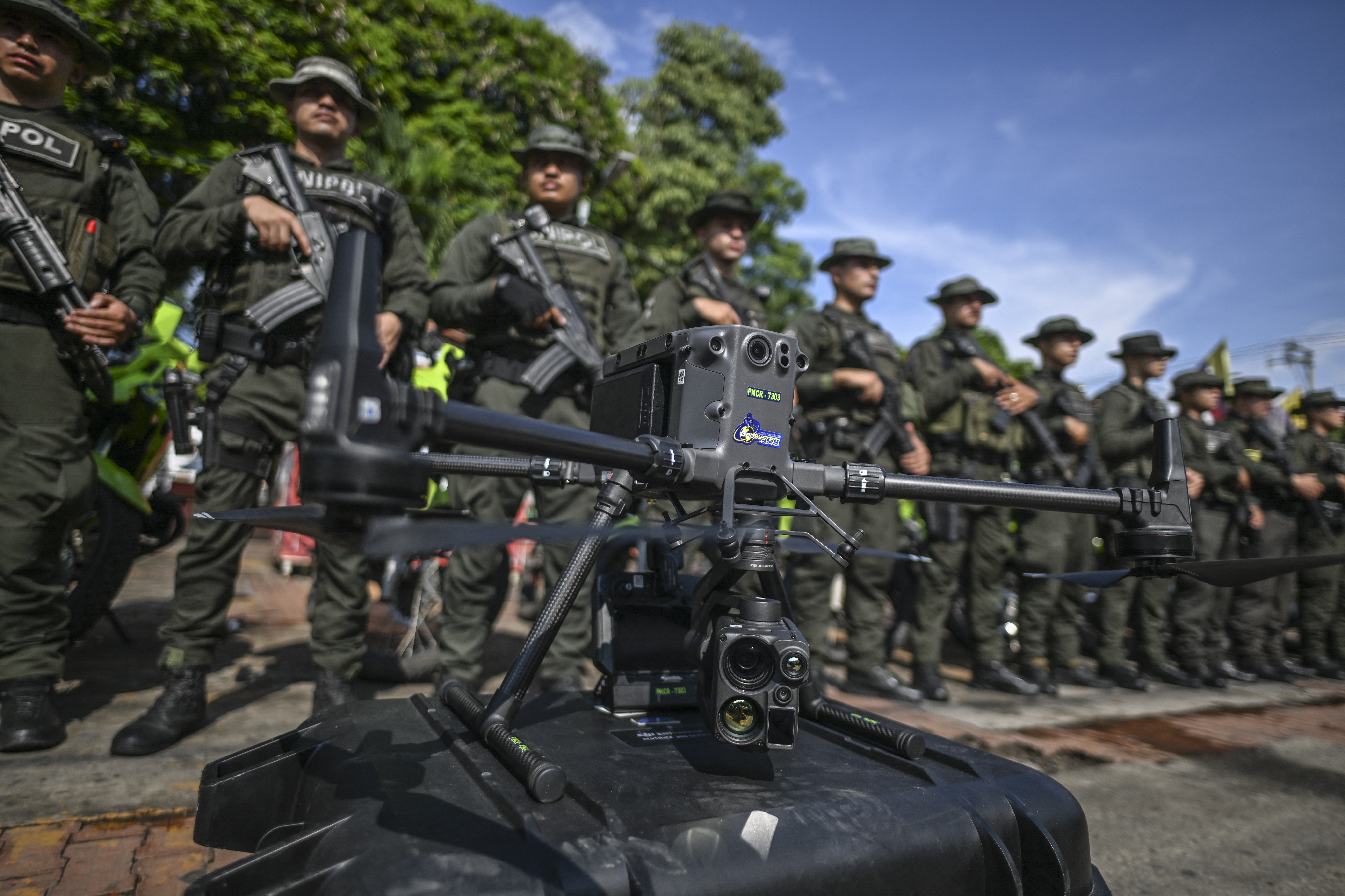 Police officers stand in formation behind a drone that will be used to increase the security in Jamundi, Valle del Cauca province, Colombia, on June 13, 2024.