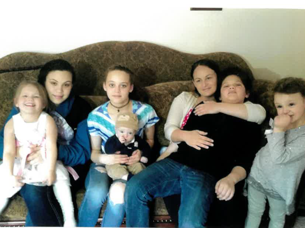 Niki Capaci (third from right) sits with her children in an old family photo. She died in May 2023 after three days in the custody of a New York jail.
