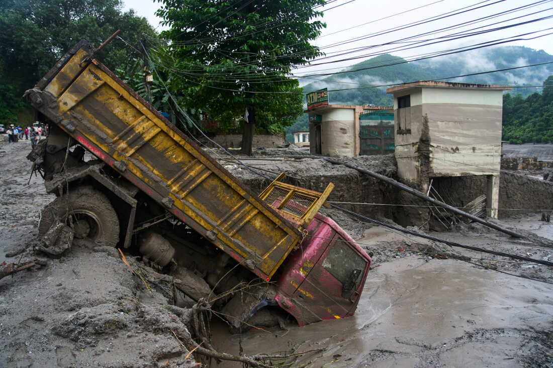 A vehicle is seen in the aftermath of flash floods in Devighat in the Nuwakot district in Nepal.