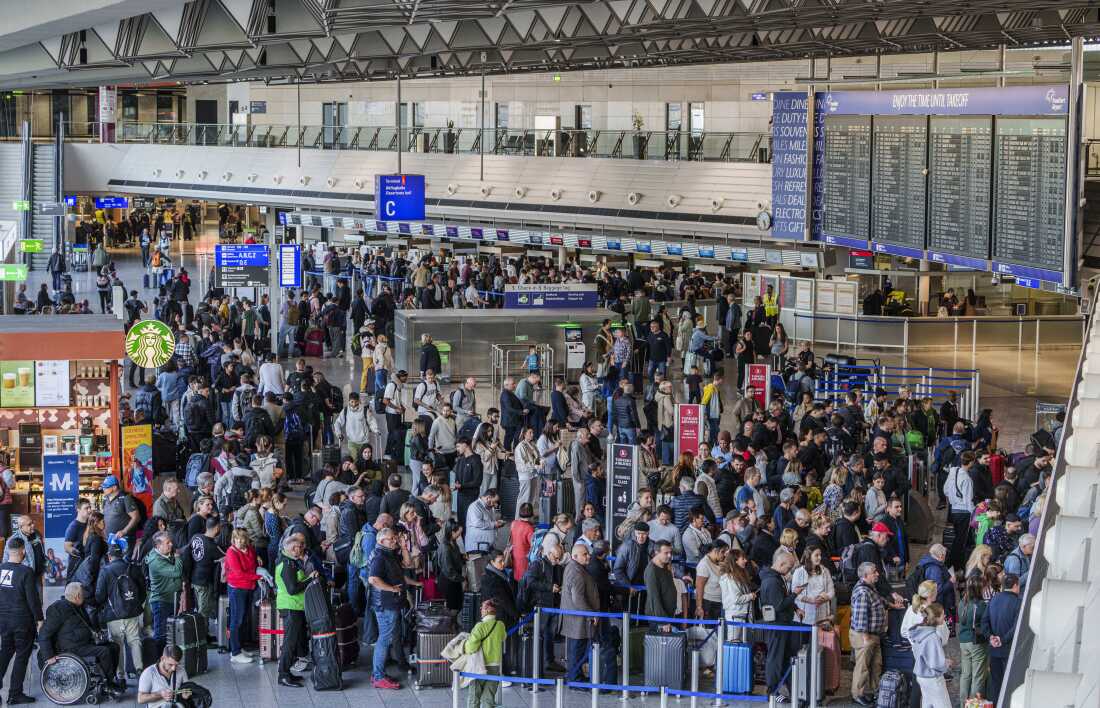 People queue in long lines in departure hall C at Rhine-Main Airport, Frankfurt, Germany on Sunday, a day ahead of a planned strike across Germany amid new contract negotiations.