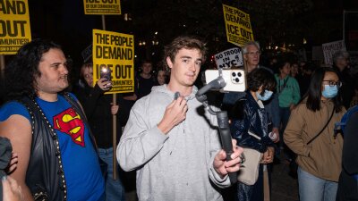 Conservative influencer Nick Shirley films protestors demonstrating against U.S. Immigration and Customs Enforcement arrests on Oct. 22 in New York City.