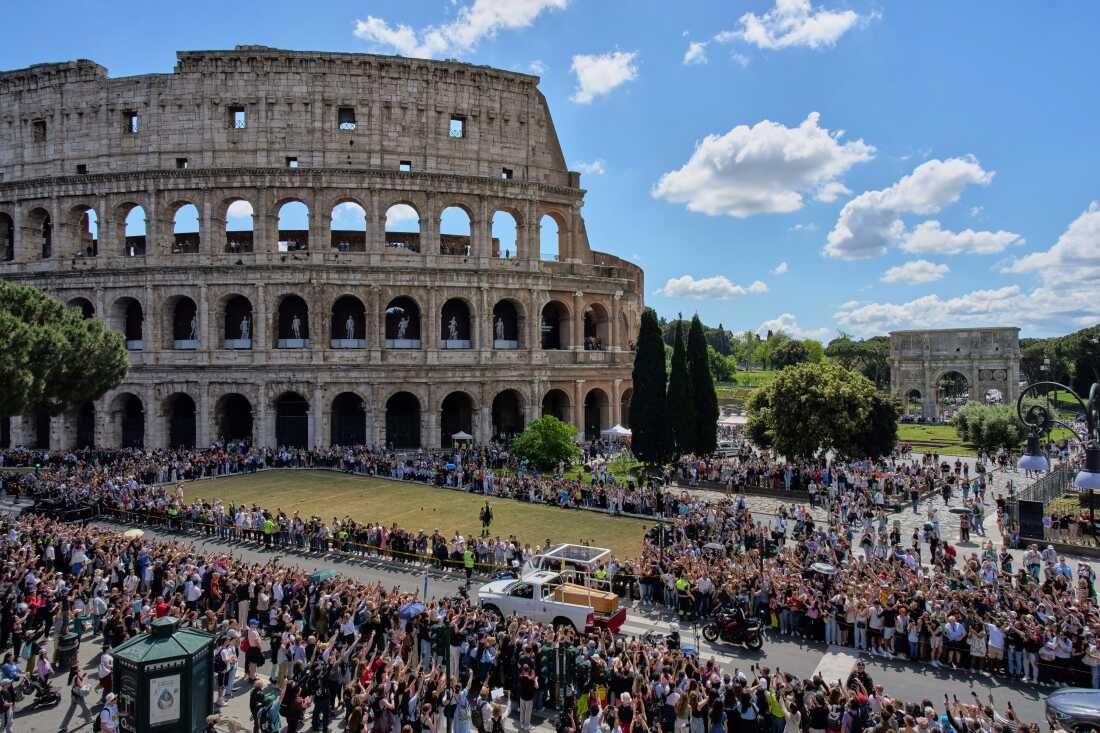 The coffin of Pope Francis passes the Colosseum in Rome.