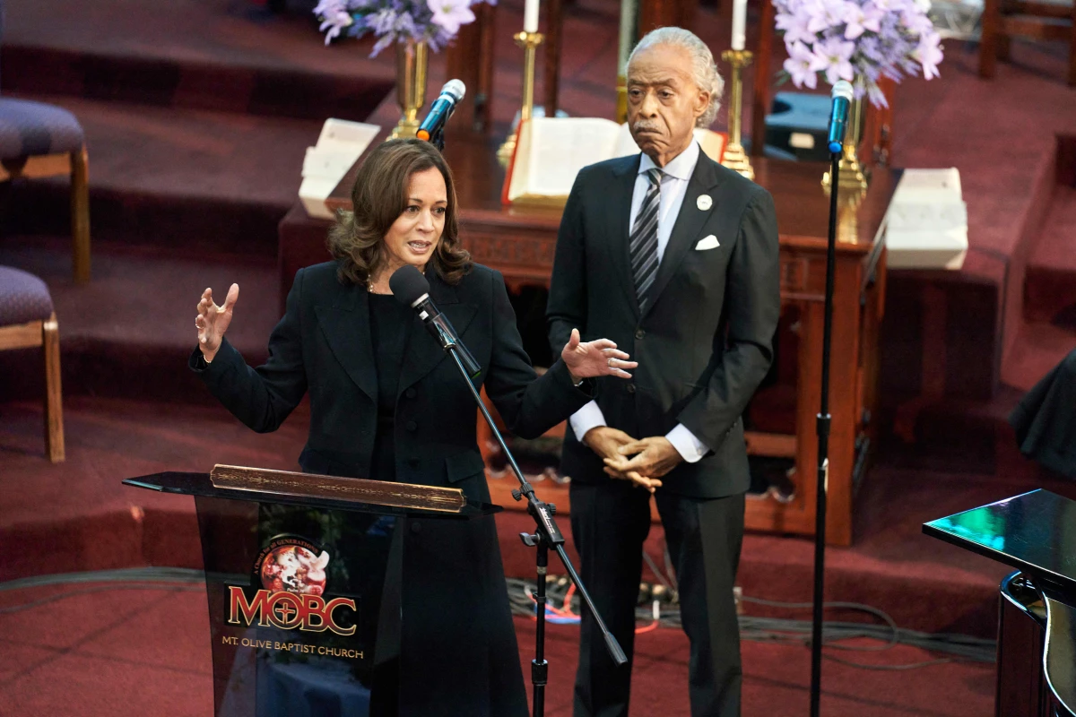 Vice President Harris speaks at the funeral service for Ruth Whitfield at Mt. Olive Baptist Church in Buffalo on May 28, 2022. The Rev. Al Sharpton stands behind her.