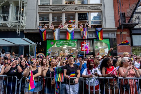 Pride Month: Celebrations & Protests - NPR crowds watch people take part in the 2025 NYC Pride March.